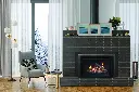 Style scandinave hivernal avec l'insert au gaz Enviro Ri30 dans un foyer en briques foncées, créant un coin lecture près d'une fenêtre