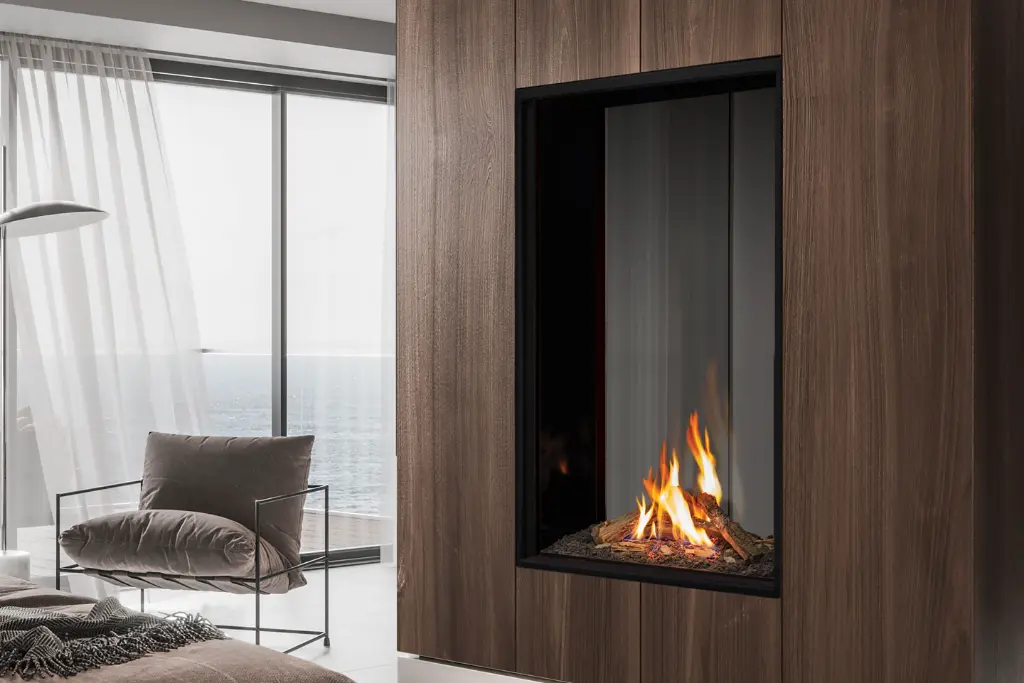 Vue en angle du foyer au gaz double face vertical Urbana U33 Tall, montrant la profondeur et la transparence de l'installation.