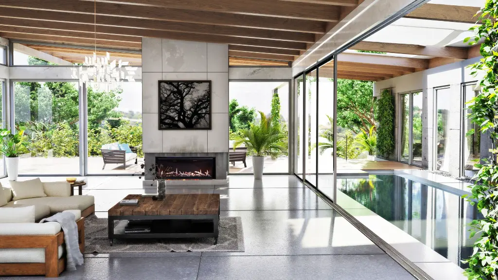 Design architectural de luxe avec le foyer au gaz linéaire Archgard Kojin 50, reconnaissable à ses panneaux supérieurs en diagonale, créant un lien parfait entre le salon et une terrasse avec piscine.