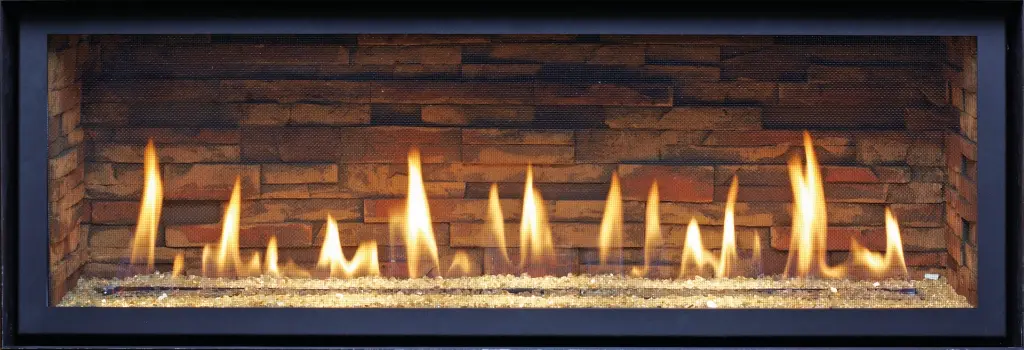 Gros plan sur l'option de lit de verre concassé du foyer 4415 HO, avec un intérieur en panneaux de briques empilées de style traditionnel.