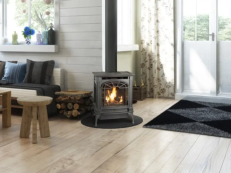 Poêle à gaz Northfield de Lopi en fonte, ajoutant une touche de charme "Modern Farmhouse" à un salon avec un mur de lattes de bois blanches.