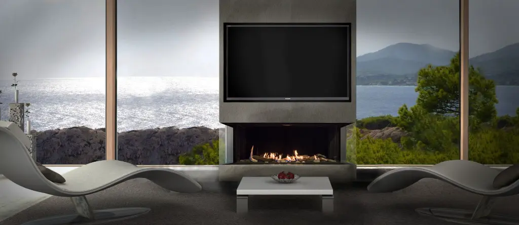 Foyer de coin au gaz Galaxy 48 de Genesis, installé sous une télévision avec une vue spectaculaire sur l'océan pour un design haut de gamme.