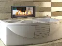 Installation unique du foyer au gaz double face Canyon 35 au-dessus d'un bain tourbillon, pour une expérience de détente et de confort ultime.